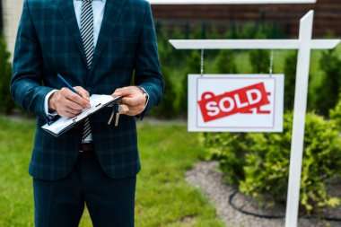 broker-writing-while Branded Realtor